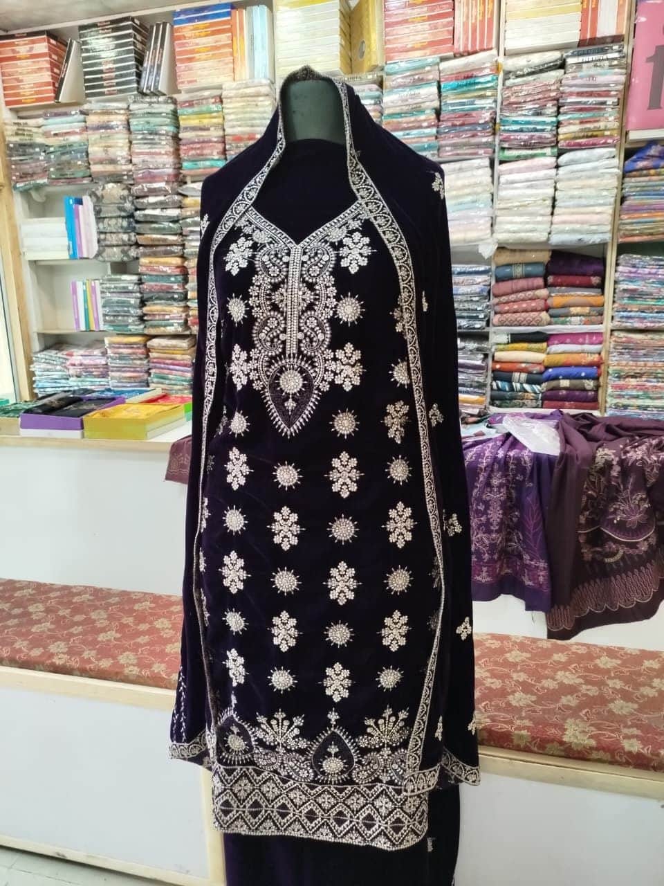 Embroidered velvet suit with matching dupatta on a mannequin at Shahzad Cloth House